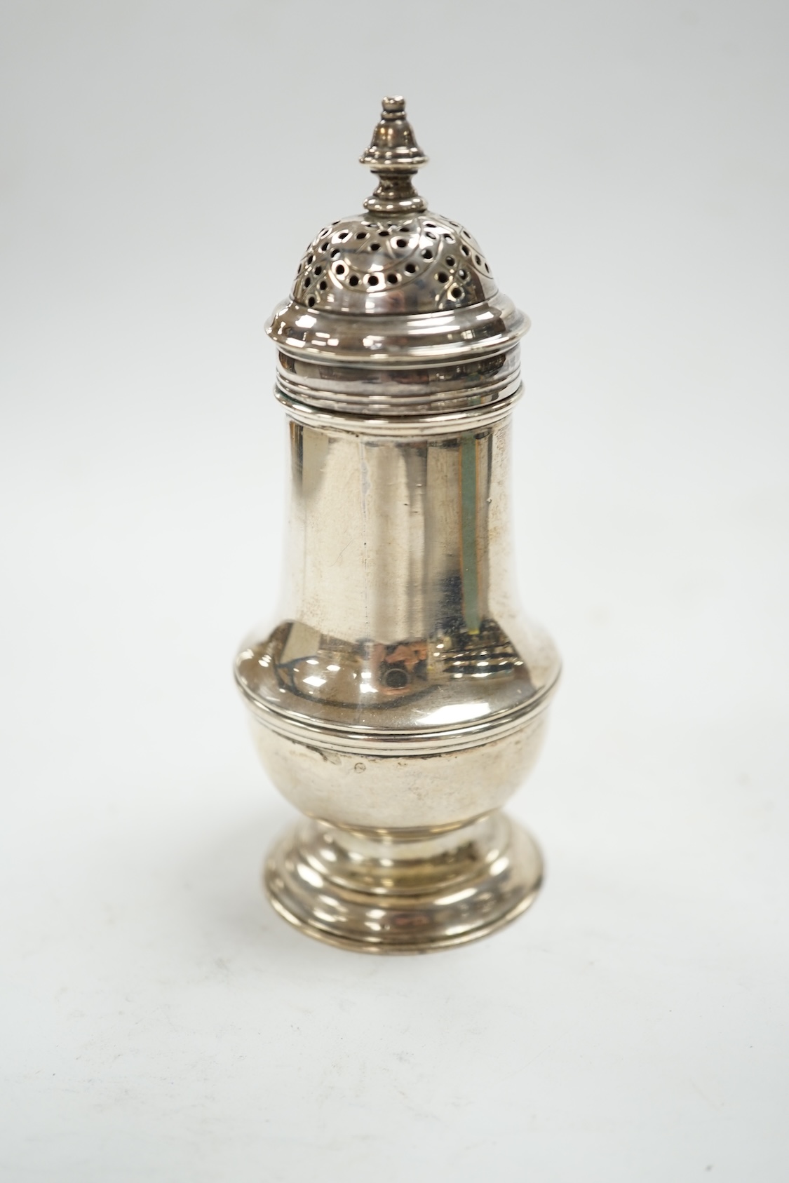 A George III silver baluster pepperette, by Samuel Wood, London, 1768, 10.7cm (cover unmarked). Condition - fair